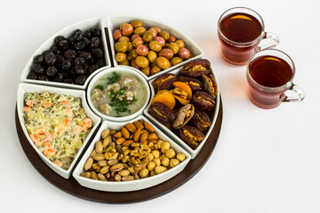 Traditional Ramadan iftar menu set with soup,olives,date fruit,nuts and  two cups of tea