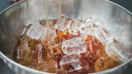 Mixed punch with fresh fruits in metal bowl