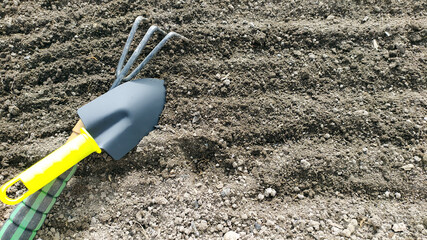 The gardening tools lie on the dug up ground. Preparing the soil for the summer cottage. Top view...