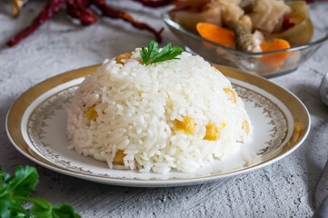 Turkish traditional food,  rice pilaf with chickpea with pickle on rustic table