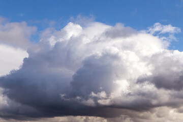 Fototapeta na wymiar Storm sky. Dark grey big cumulus clouds against blue sky background, cloud texture, thunderstorm