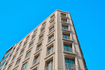 Turkey istanbul 04.03.2021. Corner view of modern architectural building in istanbul with blue sky background and many windows.