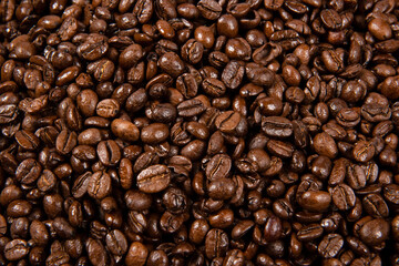 Freshly roasted coffee beans background. close up.
