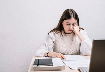 Young woman concentrated while studying at home. Study concept. Young woman.