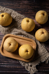 close-up of  fresh yellow pear on a wooden table