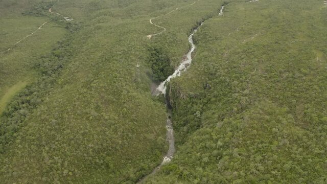 aerial image with drone of the waterfall with large volume of water in Chapada dos Veadeiros