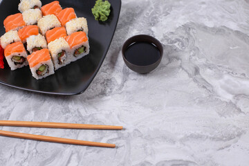 Sushi and sushi roll set on stone table