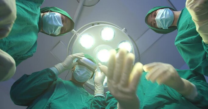 POV patient view Group of doctors putting on augmented reality headsets to performing operation on a patient in operating theater at Hightech hospital. Future healthcare and medical technology concept