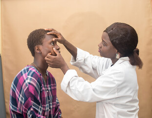 Obraz premium African female nurse , doctor or medical specialist checking a lady patient for health reasons, and also has stethoscope with her 
