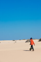 person walking on the desert