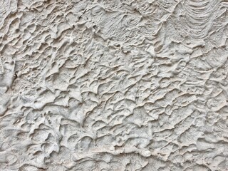 textured colored facing plaster of the street wall of the building