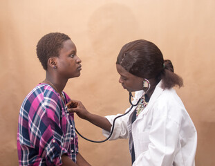 African female nurse , doctor or medical specialist checking a lady patient for health reasons, and also has stethoscope with her