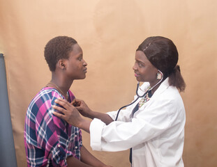 African female nurse , doctor or medical specialist checking a lady patient for health reasons, and also has stethoscope with her