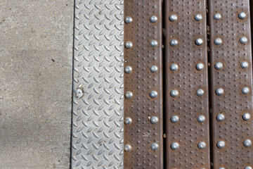 concrete, anti-slip steel plate, and rusty slats fastened with stainless steel rivets