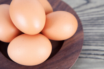 Fresh eggs in wooden plate