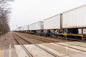 Fototapeta na wymiar Chicago, Illinois - March 12, 2021: Cargo Train Passes Through Downers Grove in Chicago.
