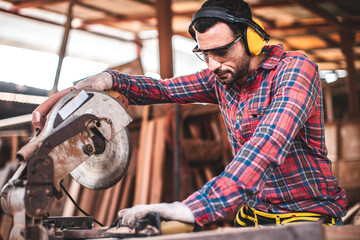 Carpenter working on woodworking machines in carpentry shop. Carpenter marks out the details of the furniture .