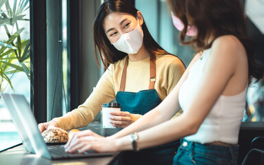 young asian woman Business people Working discuss finding new strategy solution.People discussion business plan using laptop at cafe.