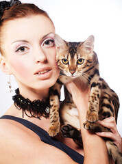 Beautiful stylish young woman dressed in retro style holding a cat
