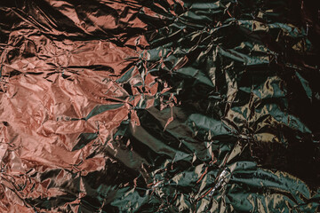 Crumpled foil texture. Crumpled paper is shiny with a color tint.