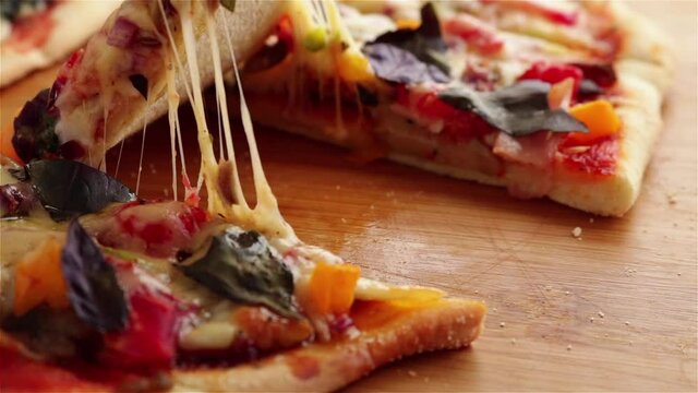 hand take delicious pizza slice with stretching cheese vegetables basil sauce