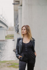 Beautiful young woman at the concrete bridge.
