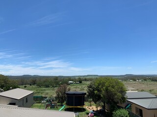 Blue sky above a green field