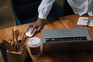 Cropped photo of woman writing making list taking notes in notepad working or learning on laptop...