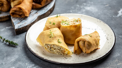 Delicious crepes rolls with chicken meat and cheese. Traditional Russian Shrovetide Maslenitsa festival meal. banner, menu recipe place for text, top view