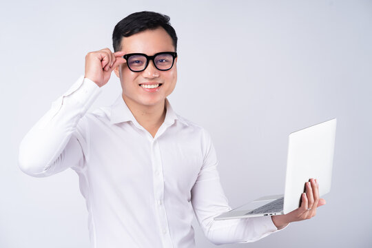 Asian businessman using laptop on white background