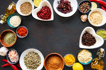 Various spices in a bowls on a black