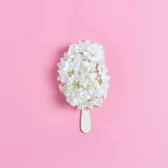 ice cream made of flowers on a pink background. fresh white hydrangeas. summer concept, flat lay, square frame