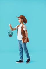 Cute little adventurer on color background