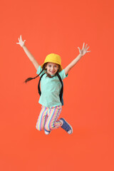 Fototapeta na wymiar Jumping little girl with backpack on color background