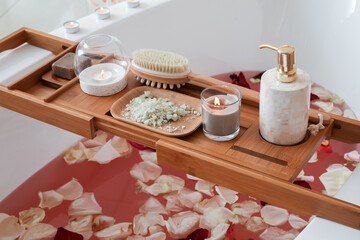 Bath with rose petals and candles prepared for relax