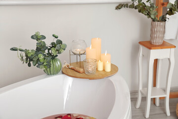 Interior of modern bathroom with burning candles
