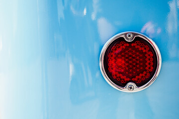 close up of rear light on blue car