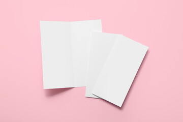 Blank brochures on color background
