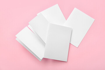 Blank brochures on color background