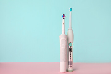 Electric tooth brushes on color background