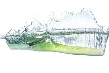 Falling of fresh leek into water against white background