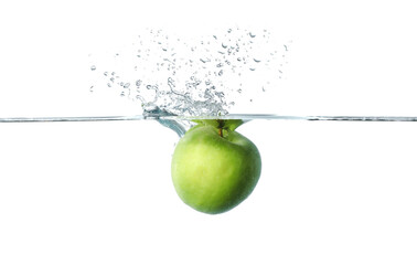 Falling of fresh green apple into water against white background