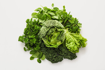 Fresh green vegetables on white background
