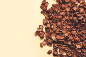 Chocolate corn flakes on color background