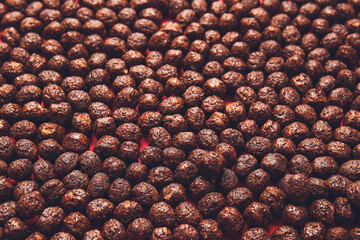 Chocolate corn balls as background, closeup