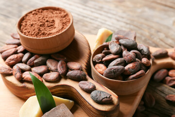 Composition with cocoa beans on wooden background, closeup