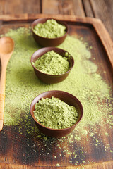 Tray with powdered matcha tea and spoon on table