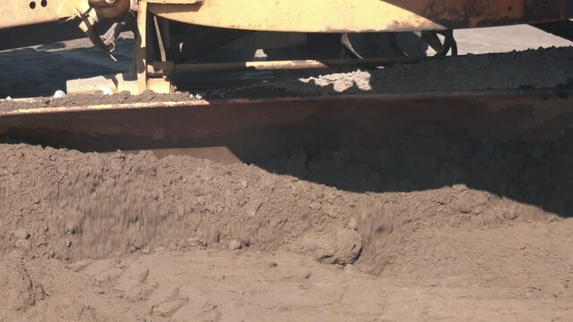 Grader Road Construction Grader industrial machine on construction of new roads. the blade of a motor grader in the process of leveling a sandy road foundation. Grader is working on road construction.