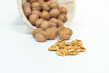 whole walnuts and kernels on white background, selective focus. Healthy food nuts.