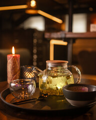 Tea brewing process, tea ceremony, freshly brewed green tea cup, warm soft light, dark background.